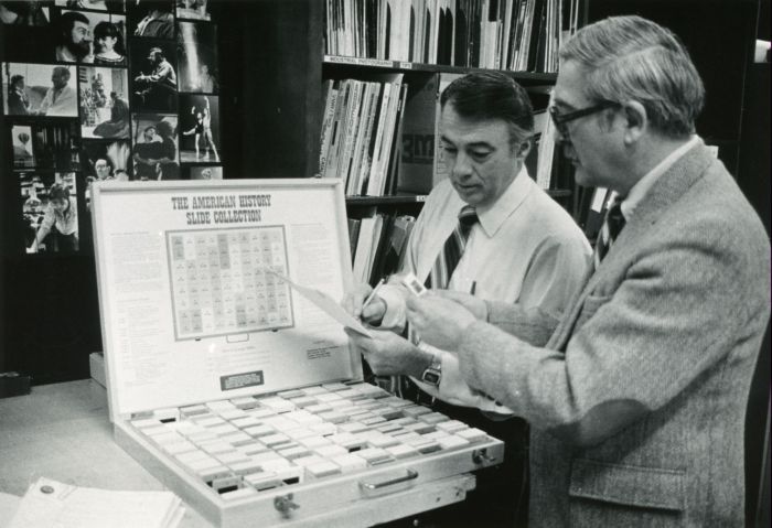 NCCC History Professors, Clyde Tyson and Graham Millar, reviewing slides for an upcoming program, 1984