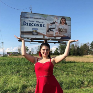 Emily Welch Ruth ’19 poses with billboard