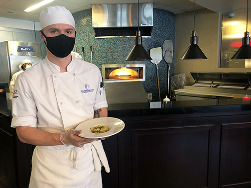 student with gnocchi dish