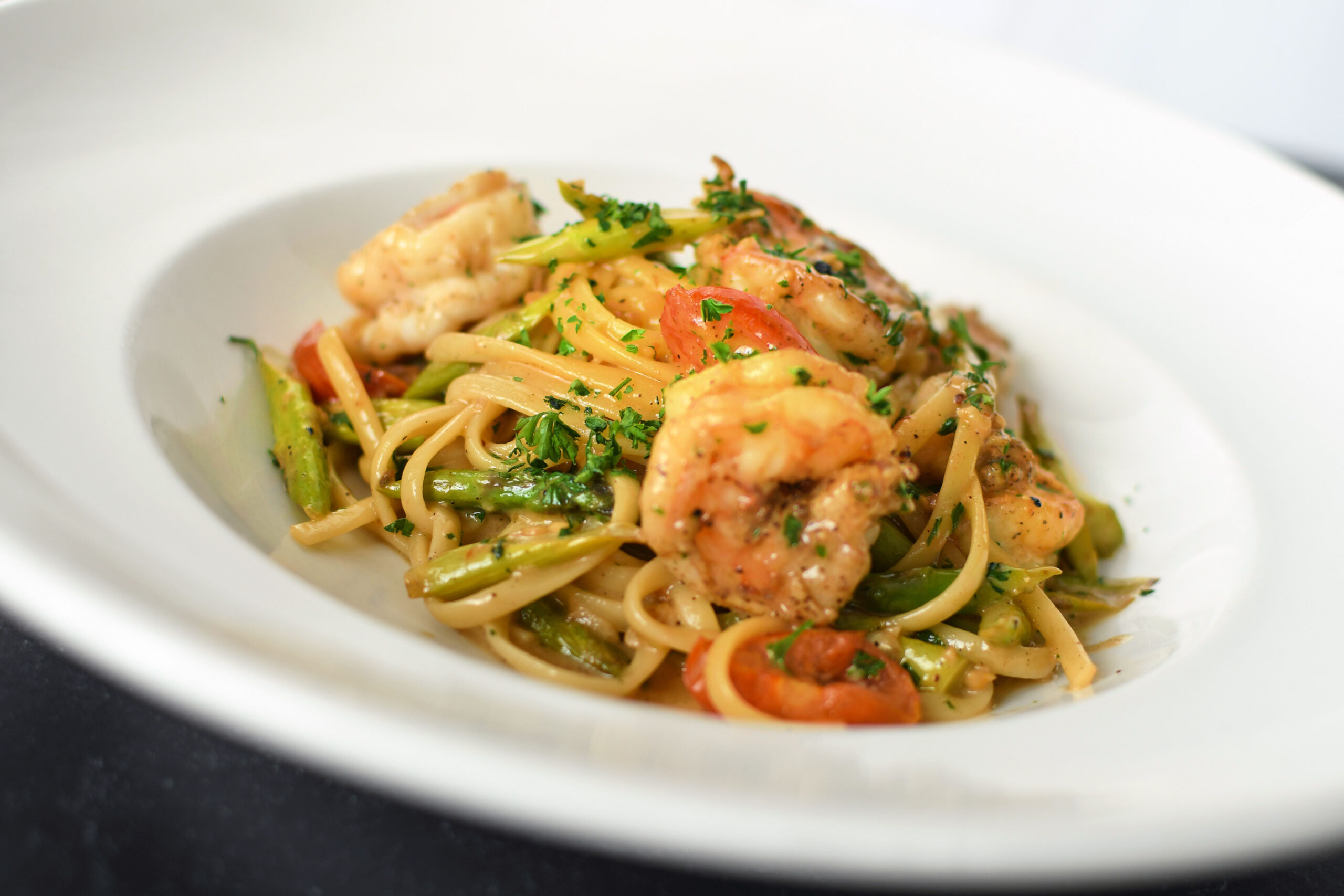 Plate of food containing pasta and shrimp