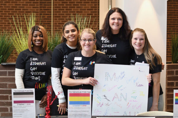 Each October, the Pride Alliance Club hosts a, “National Coming Out Day” event where students and employees can sign the ally pledge and purchase “National Coming Out Day” shirts.