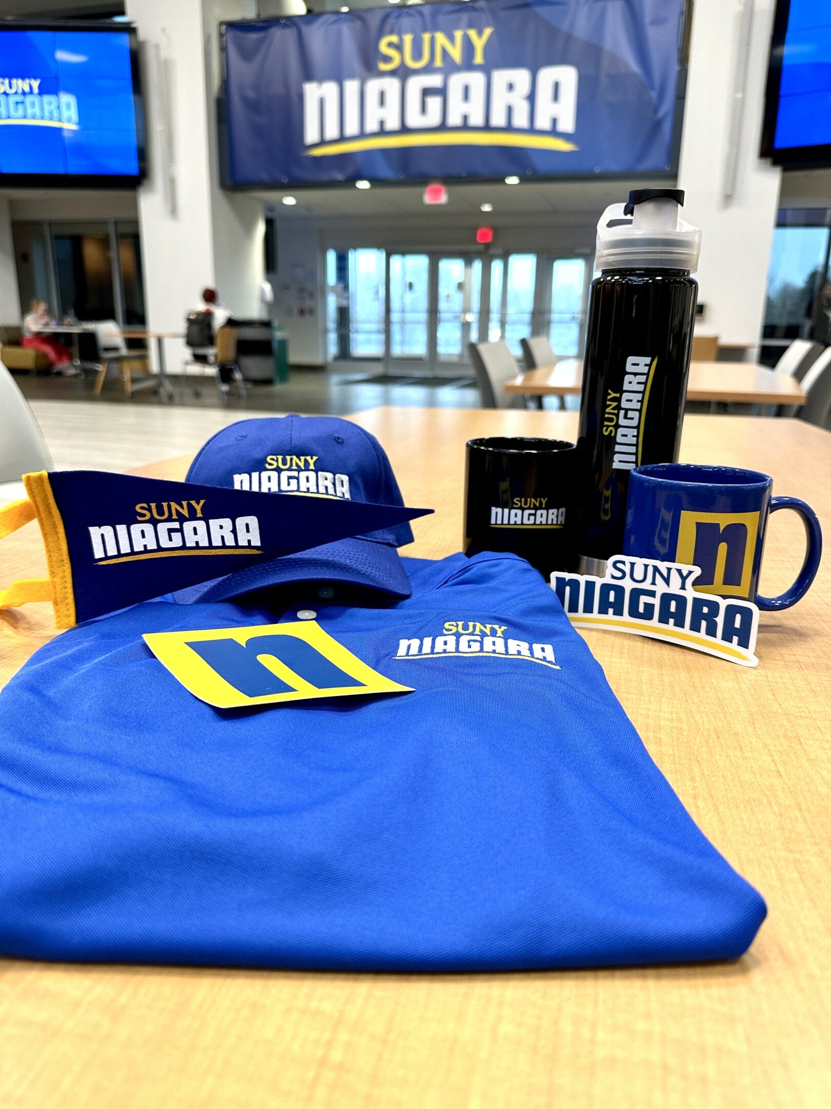 SUNY Niagara Merch. Shirt, coffee mugs, stickers, hat, and more.